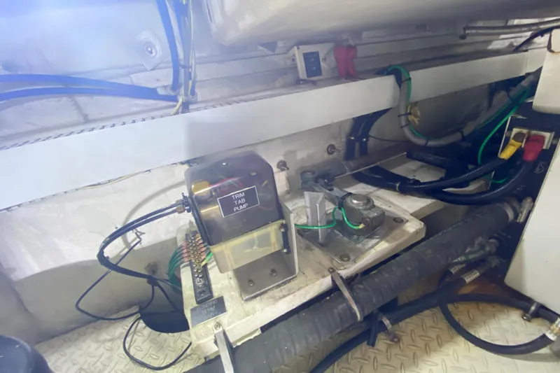 Slide: The Image of Engine compartment of 2006 Cruisers Yachts 520 Express showing trim tab pump and wiring. - 102
