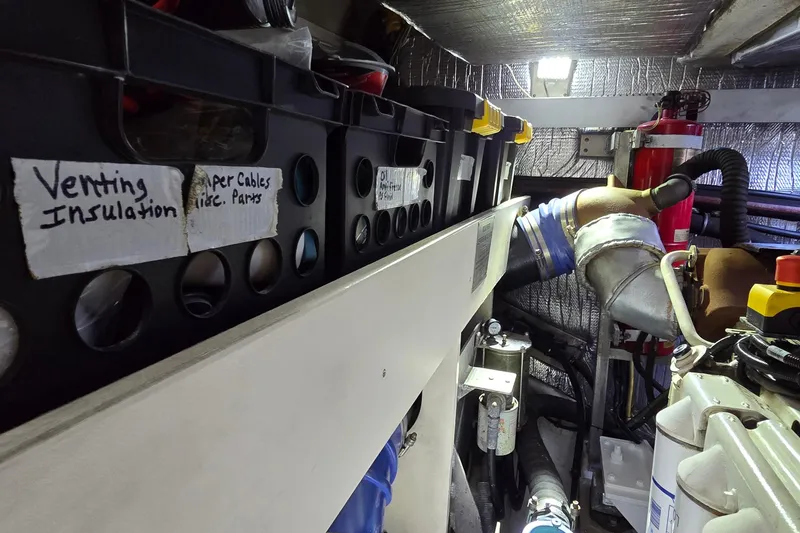 Slide: The Image of Engine room of 2006 Cruisers Yachts 520 Express with labeled storage bins and equipment. - 101