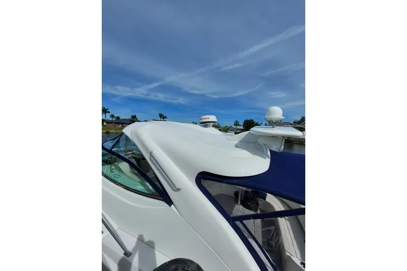 Slide: The Image of 2006 Cruisers Yachts 520 Express, sleek design, docked under clear blue sky. - 29