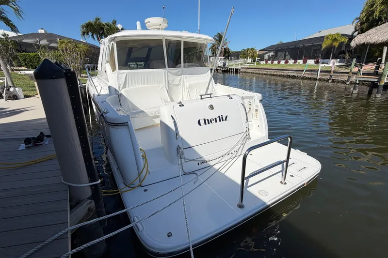 Slide: The Image of 2005 Tiara Yachts 3600 Sovran docked in a sunny marina setting. - 1