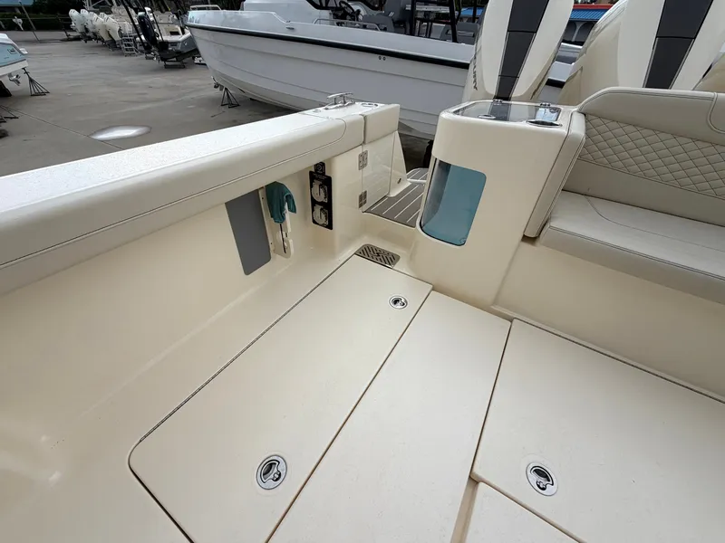 Slide: The Image of The image shows the deck of a 2025 Scout 400 LXF boat with storage and seating. - 18