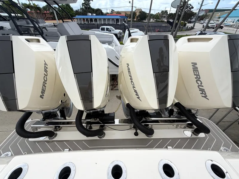 Slide: The Image of Four Mercury outboard engines are mounted on the stern of a Scout 400 LXF boat. - 15