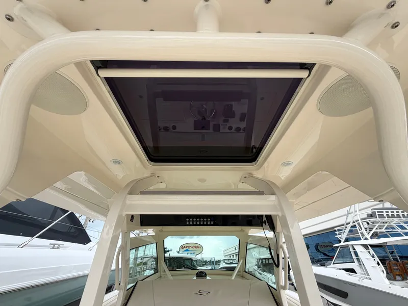 Slide: The Image of The image shows the roof of a 2025 Scout 400 LXF boat with a glass sunroof. - 26