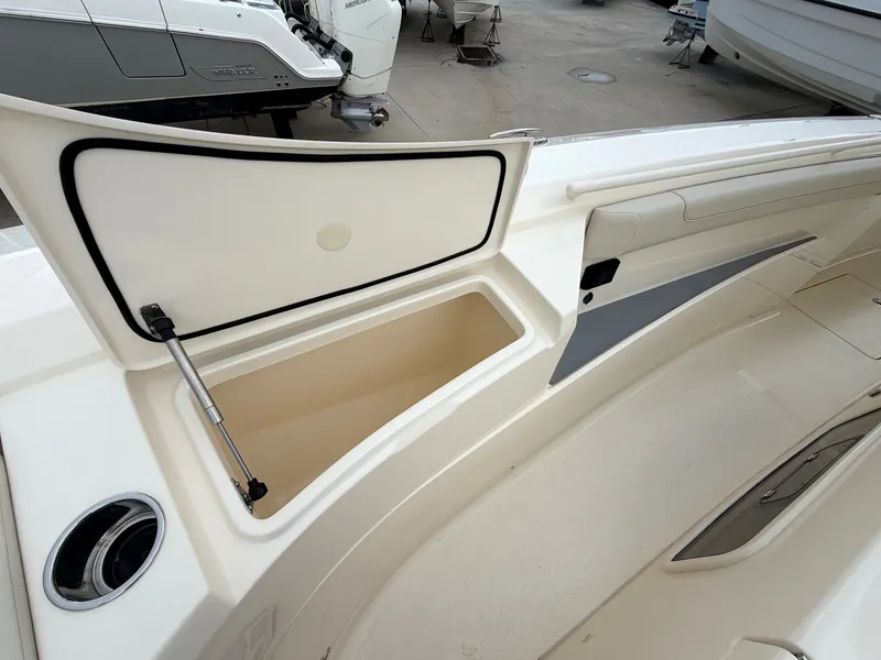 Slide: The Image of The image shows the storage compartment of a 2025 Scout 400 LXF boat with an open lid. - 45