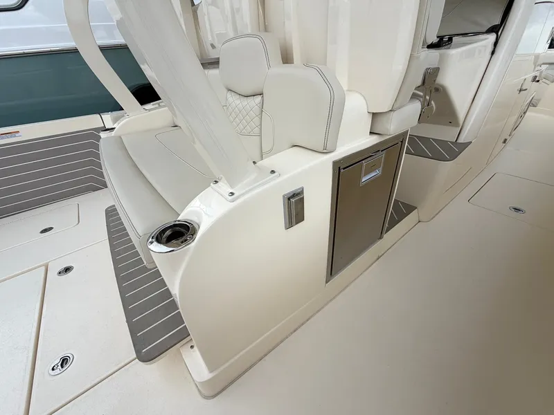 Slide: The Image of The image shows the interior of a 2025 Scout 400 LXF boat with sleek seating and storage. - 28