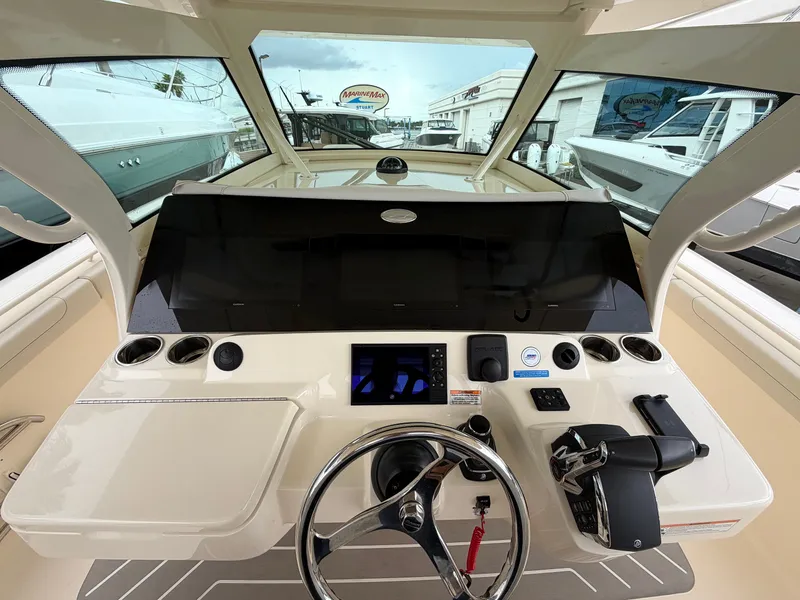 Slide: The Image of The cockpit of the 2025 Scout 400 LXF features a modern helm with steering wheel and instruments. - 34