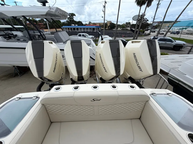 Slide: The Image of The image shows the stern of a Scout 400 LXF with four Mercury outboard engines. - 14