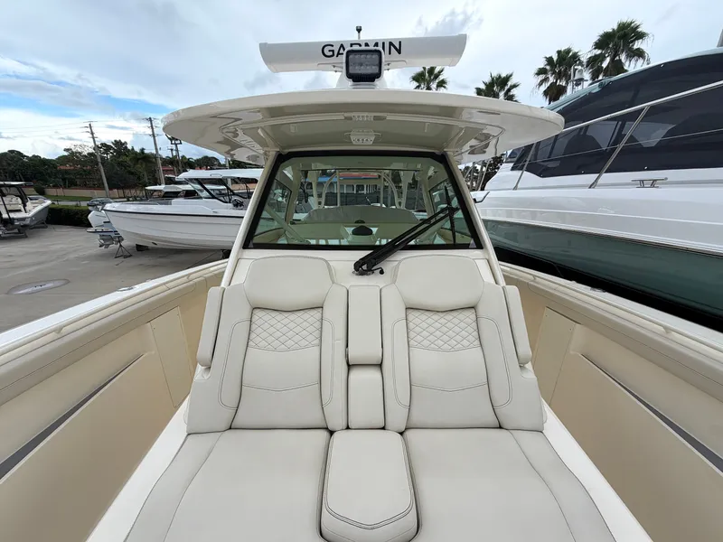 Slide: The Image of The image shows the cockpit of a 2025 Scout 400 LXF boat with luxurious seating. - 44