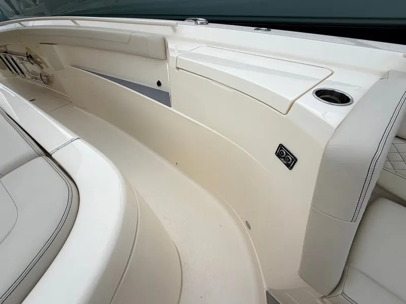 Slide: The Image of The image shows the sleek, cream-colored deck of a 2025 Scout 400 LXF boat. - 46