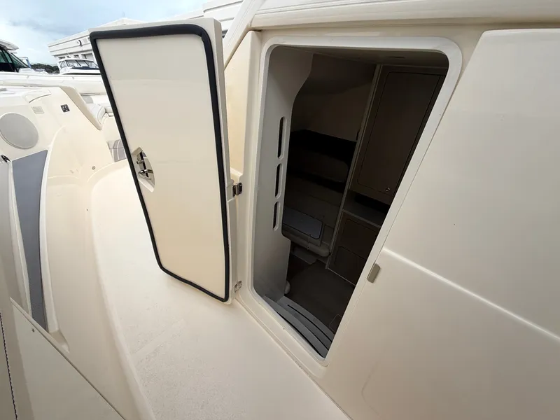 Slide: The Image of The 2025 Scout 400 LXF features an open door leading to an interior space with storage. - 48