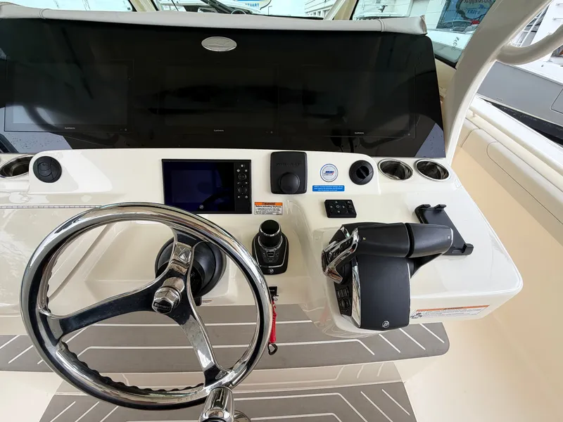 Slide: The Image of The image shows the helm of a 2025 Scout 400 LXF boat with modern controls. - 35