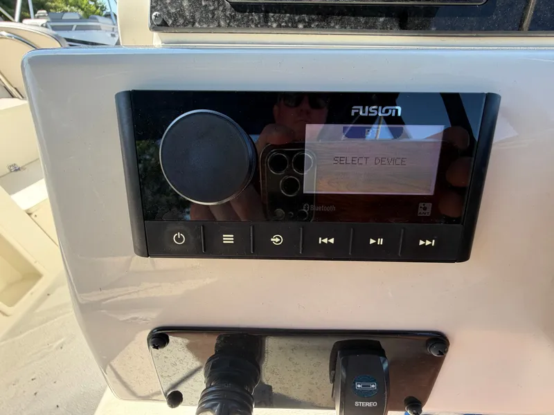 Slide: The Image of The image shows a Fusion audio system on a boat panel. - 9