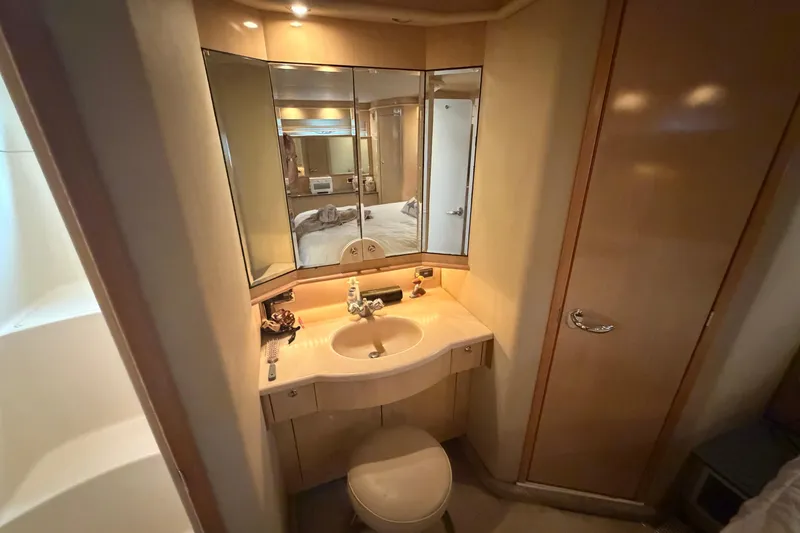 Slide: The Image of Bathroom interior of 2002 Sea Ray 480 Motor Yacht with mirrored vanity and sink. - 32