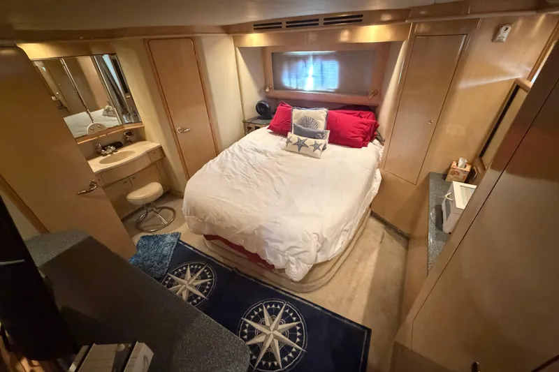 Slide: The Image of Luxurious bedroom interior of 2002 Sea Ray 480 Motor Yacht with cozy bed and elegant decor. - 28