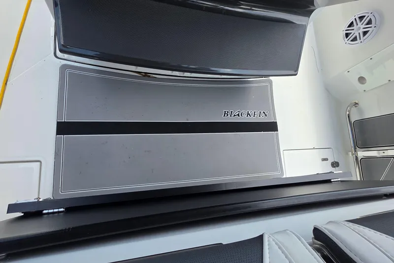 Slide: The Image of 2021 Blackfin 272 CC boat deck with logo, featuring sleek design and modern amenities. - 16