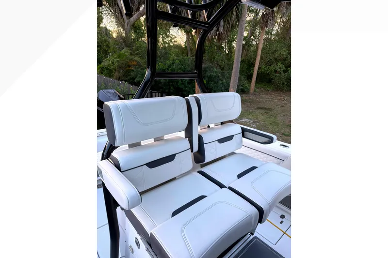 Slide: The Image of 2021 Blackfin 272 CC boat seating with white upholstery and black accents. - 8