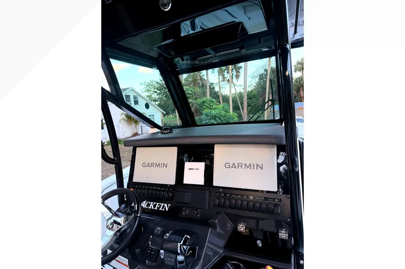 Slide: The Image of 2021 Blackfin 272 CC boat dashboard with Garmin navigation displays and controls. - 11