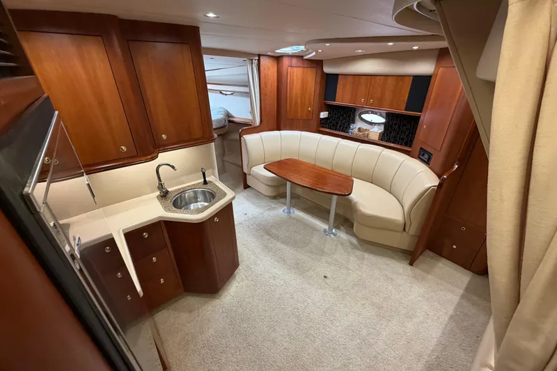 Slide: The Image of Luxurious interior of 2001 Cruisers Yachts 3672 Express with elegant wood cabinetry and seating. - 34