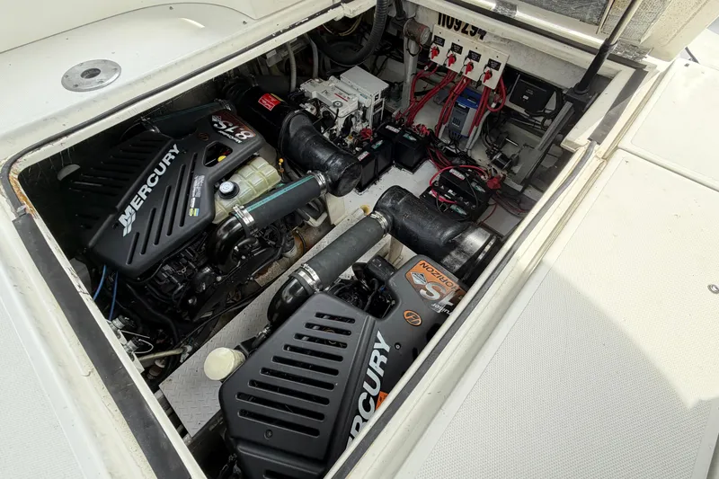 Slide: The Image of Engine compartment of 2001 Cruisers Yachts 3672 Express with Mercury engines and electrical components. - 41