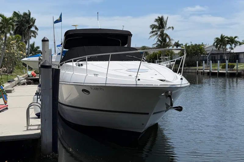 Slide: The Image of 2001 Cruisers Yachts 3672 Express docked in a sunny marina setting. - 4