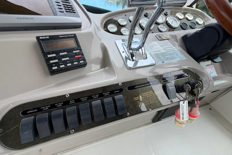 Slide: The Image of 2001 Cruisers Yachts 3672 Express dashboard with controls and navigation instruments. - 19
