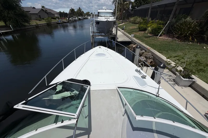 Slide: The Image of 2001 Cruisers Yachts 3672 Express docked in a scenic canal setting. - 20