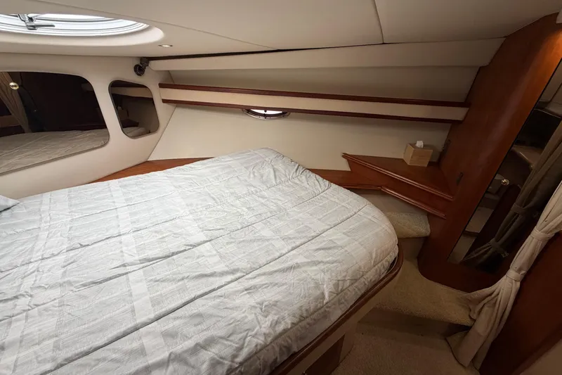 Slide: The Image of 2001 Cruisers Yachts 3672 Express cabin interior with bed and wooden accents. - 39