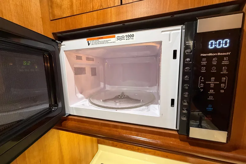 Slide: The Image of Hamilton Beach microwave inside 2001 Cruisers Yachts 3672 Express, with wooden cabinetry. - 29