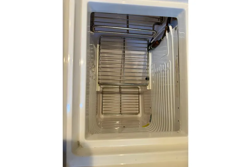 Slide: The Image of Interior view of a 1977 Hans Christian Ketch refrigerator with wire shelves. - 34