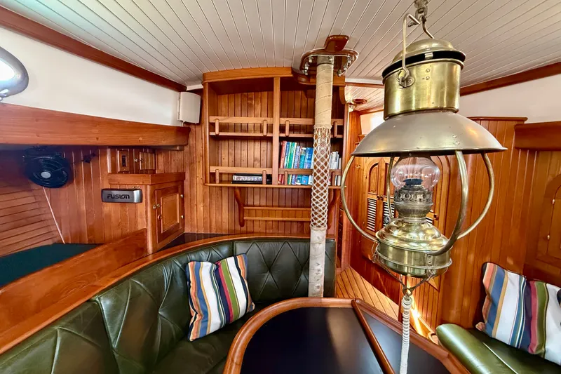Slide: The Image of Interior of 1977 Hans Christian Ketch with wooden decor and vintage lantern. - 37