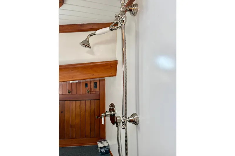 Slide: The Image of Vintage 1977 Hans Christian Ketch shower with elegant chrome fixtures and wooden accents. - 48