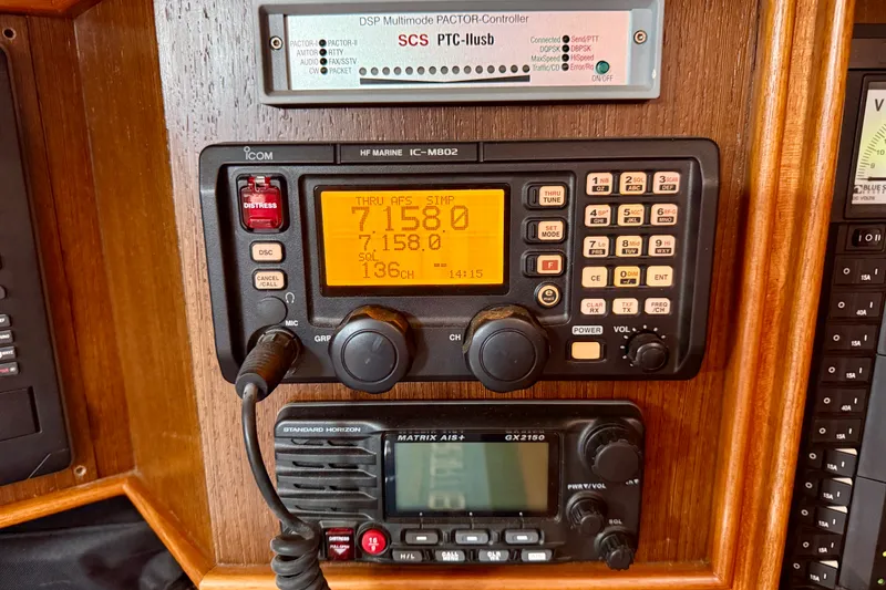 Slide: The Image of Radio equipment on a 1977 Hans Christian Ketch sailboat, featuring Icom and Standard Horizon devices. - 53