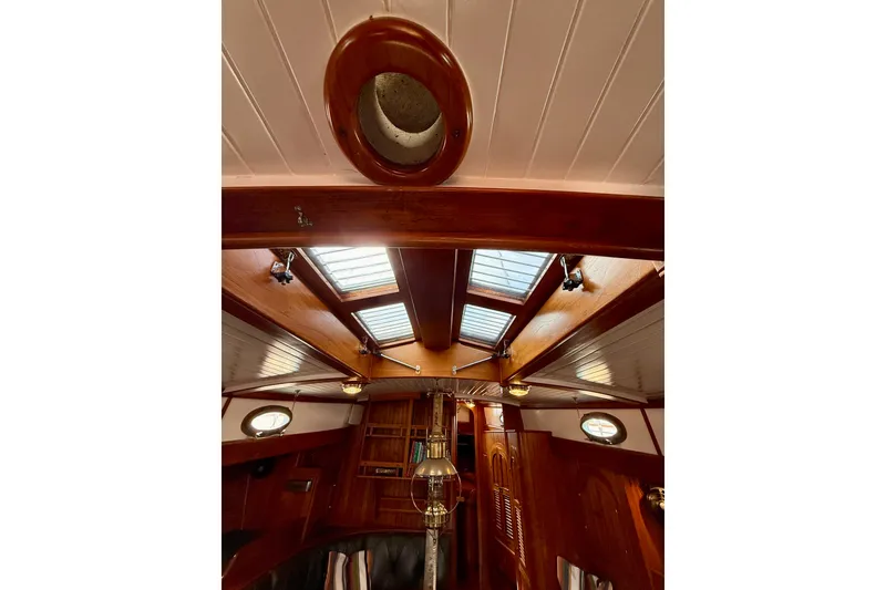 Slide: The Image of Interior view of 1977 Hans Christian Ketch sailboat with wooden finishes and skylights. - 26