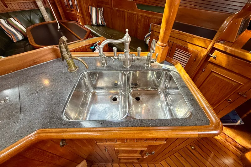 Slide: The Image of 1977 Hans Christian Ketch interior with dual stainless steel sink and wooden cabinetry. - 33
