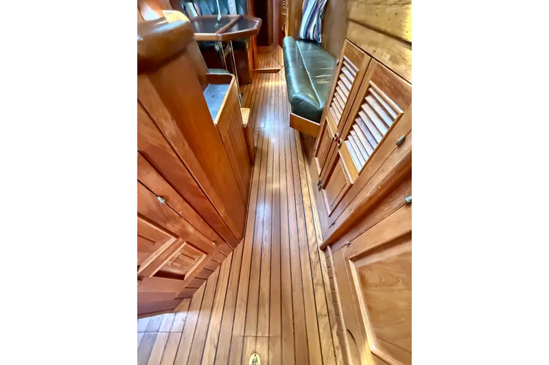 Slide: The Image of Interior of 1977 Hans Christian Ketch with wooden flooring and seating area. - 27
