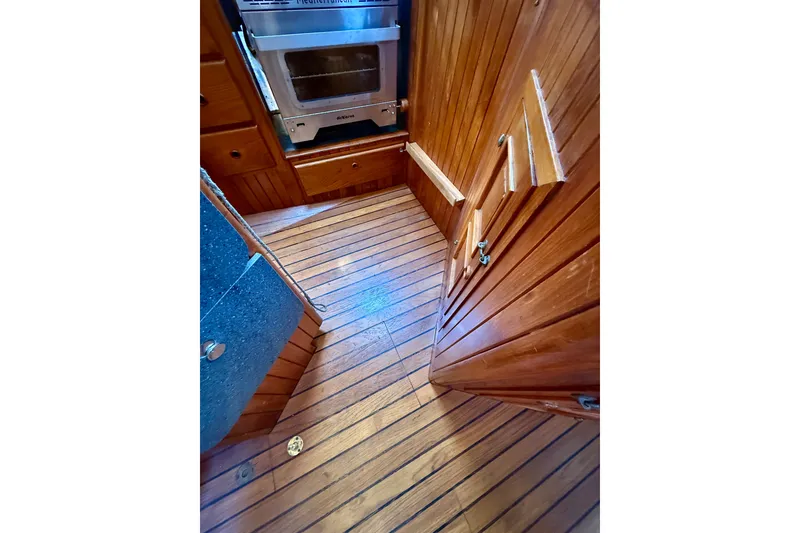 Slide: The Image of Wood-paneled interior of 1977 Hans Christian Ketch, featuring stove and cabinetry. - 29