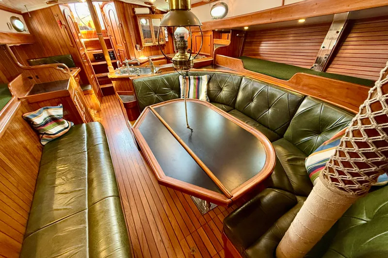Slide: The Image of Luxurious 1977 Hans Christian Ketch interior with wood paneling and green leather seating. - 38
