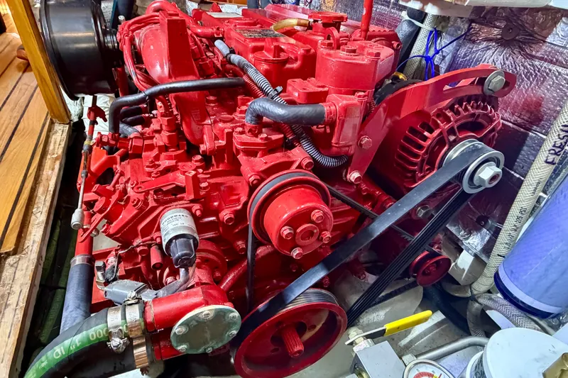 Slide: The Image of Red engine of a 1977 Hans Christian Ketch sailboat, showcasing detailed mechanical components. - 21