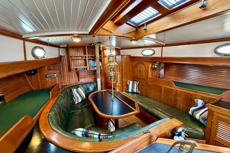 Slide: The Image of Interior of 1977 Hans Christian Ketch sailboat with wooden furnishings and cozy seating area. - 36