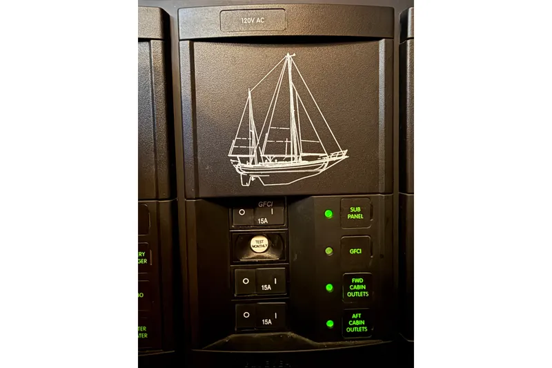 Slide: The Image of Electrical panel with sailboat illustration on a 1977 Hans Christian Ketch. - 68