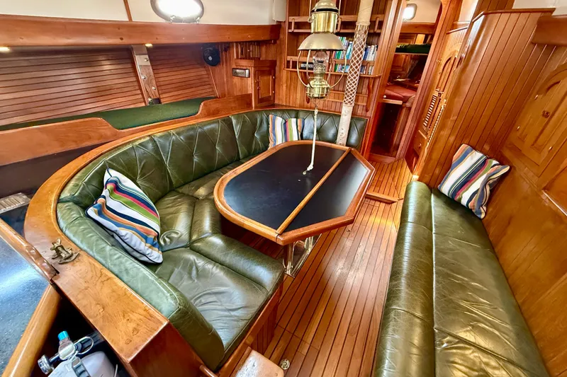Slide: The Image of Luxurious 1977 Hans Christian Ketch interior with green leather seating and striped pillows. - 39