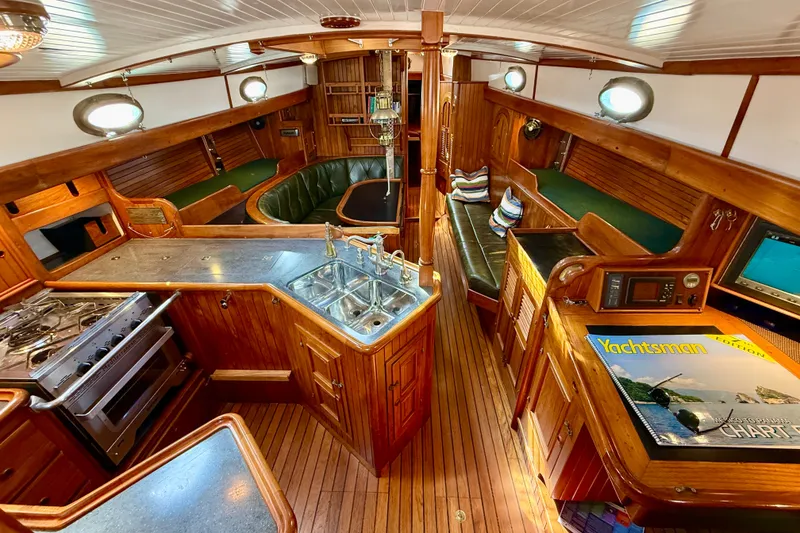 Slide: The Image of Interior of a 1977 Hans Christian Ketch sailboat with wooden furnishings and nautical decor. - 23