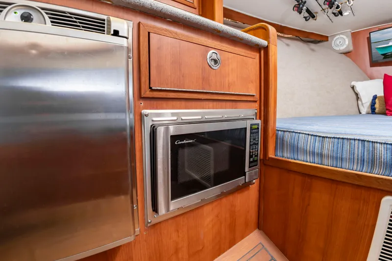 Slide: The Image of Interior of the 2006 Custom Carolina 36 Express with microwave and refrigerator. - 35