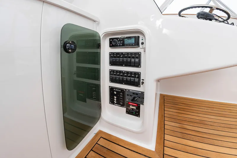 Slide: The Image of The image shows the cockpit of a 2006 Custom Carolina 36 Express with a helm and wood deck. - 22