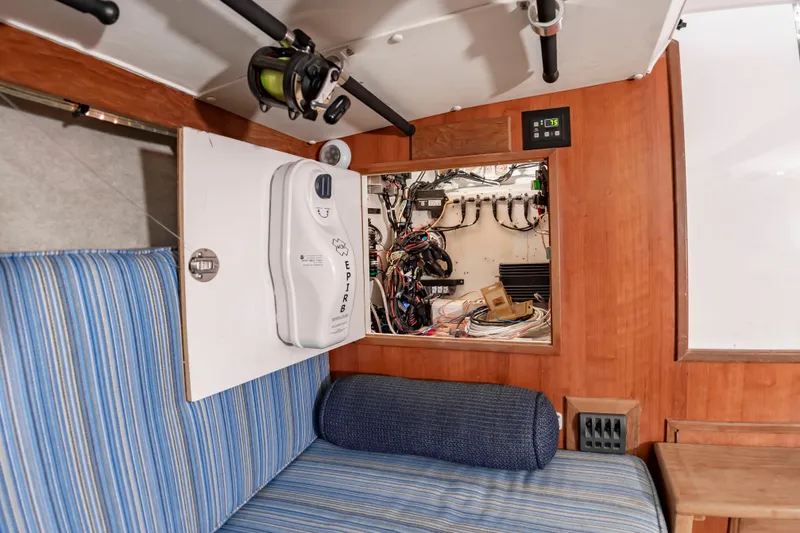 Slide: The Image of Interior of a 2006 Custom Carolina 36 Express with blue upholstery and electronic equipment. - 44