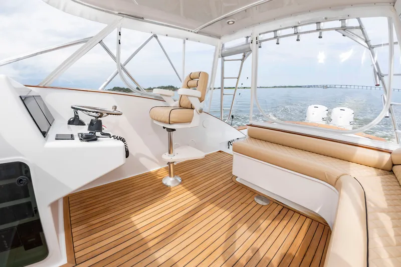 Slide: The Image of The 2006 Custom Carolina 36 Express cockpit features a sleek helm and comfortable seating. - 21