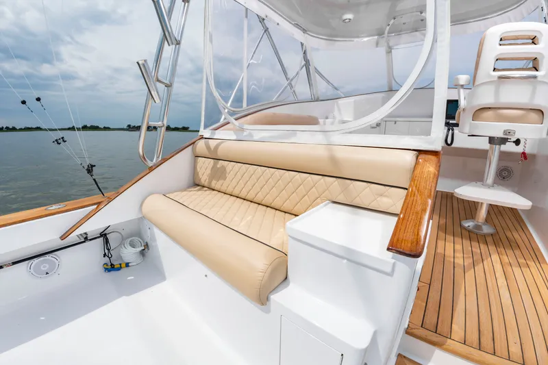 Slide: The Image of The image shows the cockpit of a 2006 Custom Carolina 36 Express with beige upholstered seating. - 16