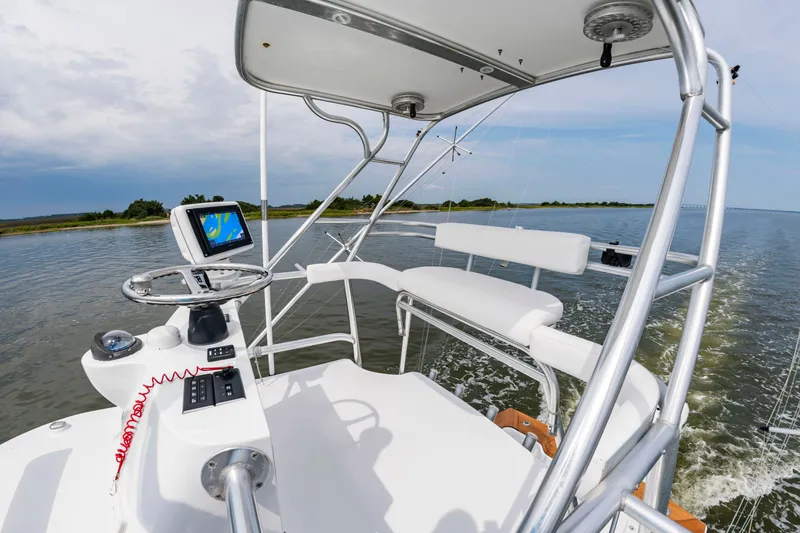 Slide: The Image of The image shows the helm of a 2006 Custom Carolina 36 Express boat. - 27