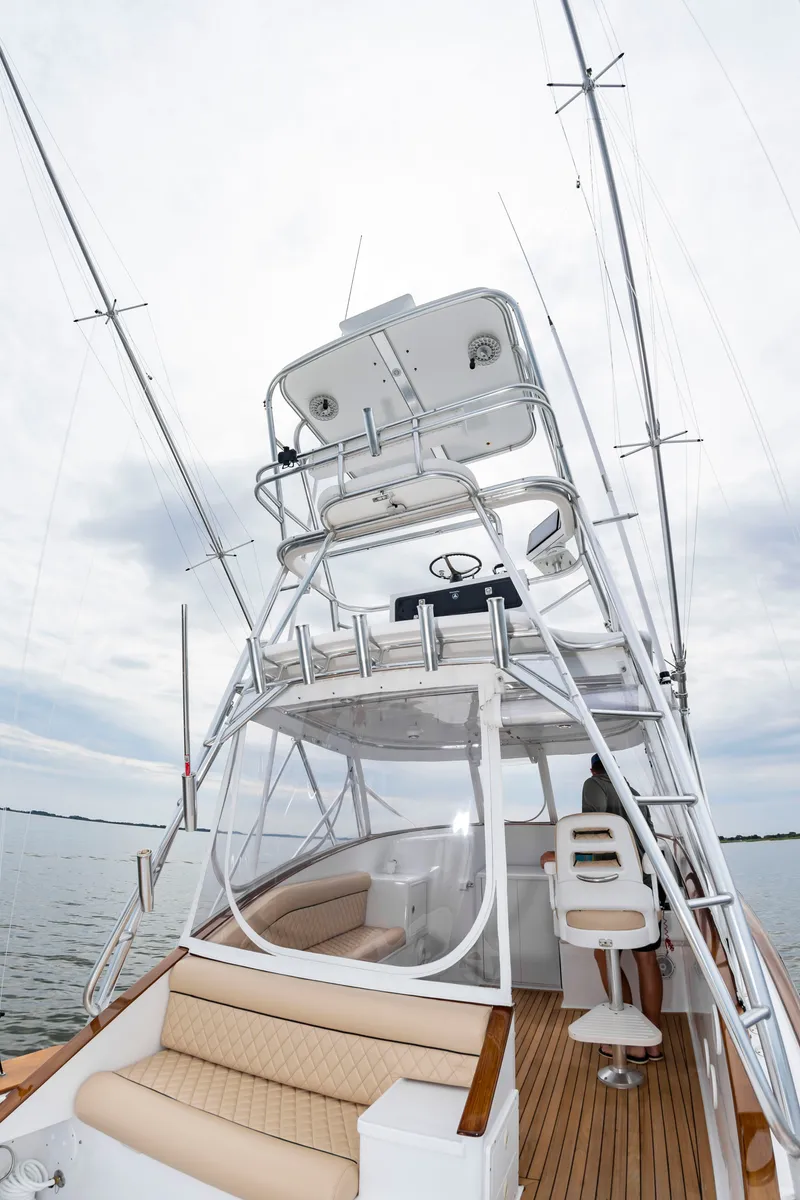 Slide: The Image of The image shows a 2006 Custom Carolina 36 Express boat with an elevated helm station. - 23