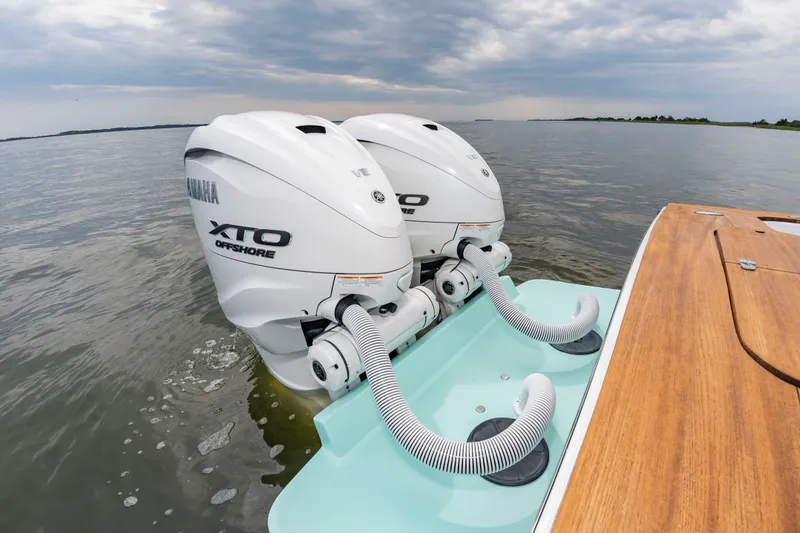 Slide: The Image of Two Yamaha XTO Offshore engines on a Custom Carolina 36 Express boat on calm water. - 15